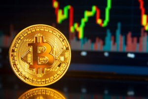 Blog Banking regulation: Image shows a Bitcoin physical coin in the foreground, and a pricing chart in the background
