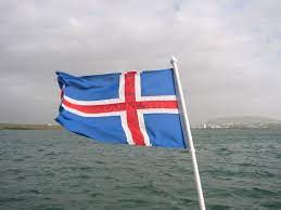 Blog Political development: An image of a Iceland flag with the ocean behind it