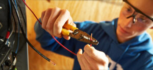 Blog Job training: The image is of someone trimming an electrical work that inside an electrical distribution panel