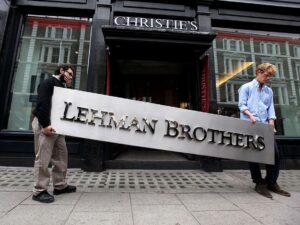 Blog Angrynomics: Image of the Lehman Brothers sign being carried down the street