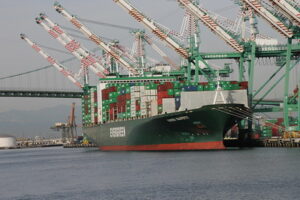 Blog Cost of shipping: Image of an Evergreen ship docked at the port of Los Angeles